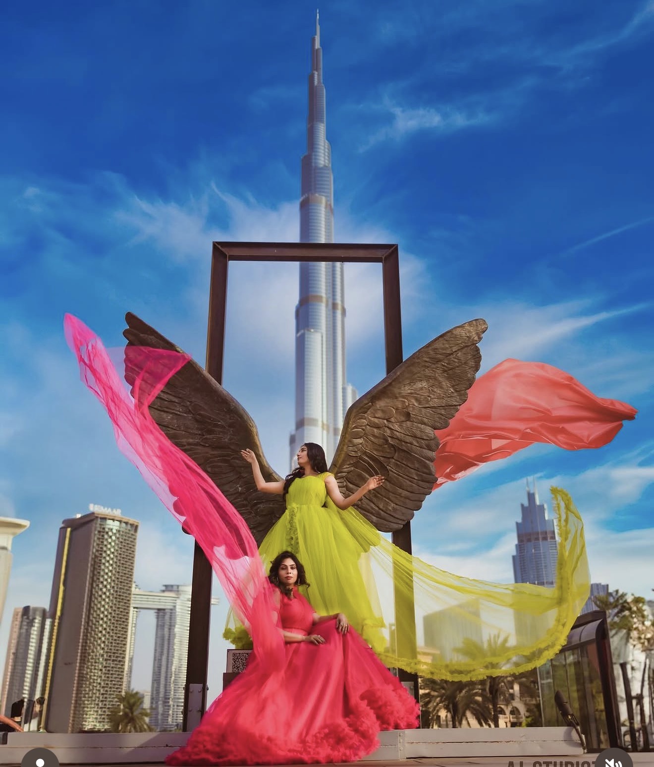 Creative fashion portrait of Anju and Soumya framed by the Burj Khalifa in Dubai